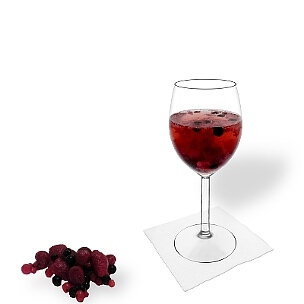 Berry Punch served in a red wine glass, the common way of presenting that delicious party mixture.