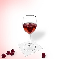 Raspberry punch in a red wine glass.